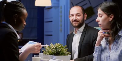 portrait-smiling-manager-man-looking-front-working-company-strategy-meeting-office-room-late-night